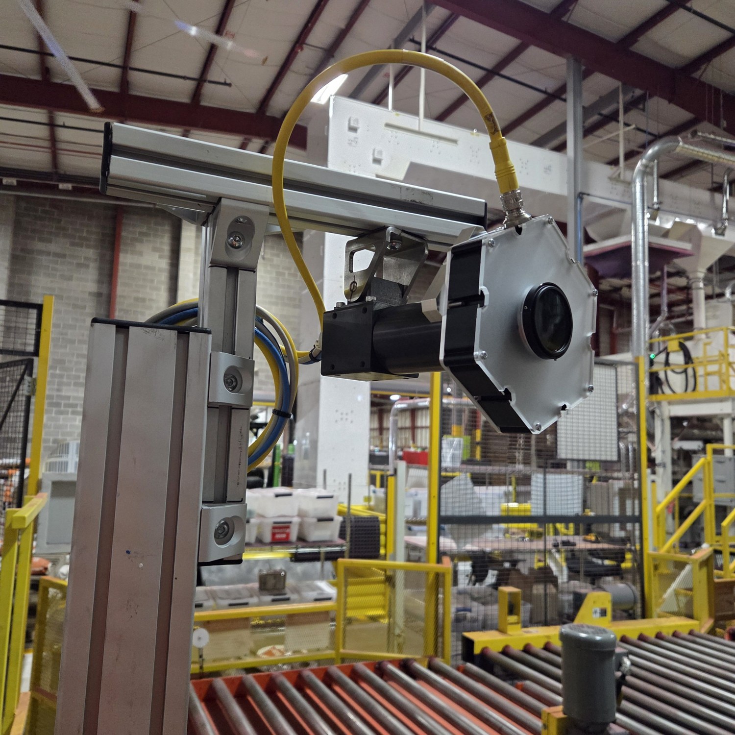 Camera on its mounting frame above the roller conveyor